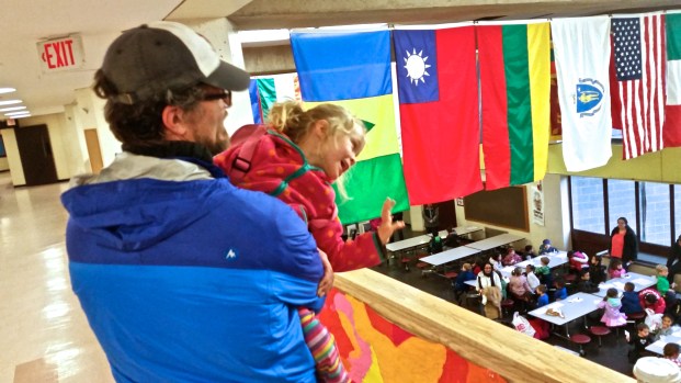 "Hi EVERYBODY down there!  I'm up here, in my daddy's arms!"